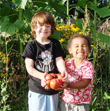 Adorable Grandkids offering you a tomato